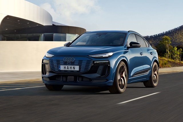 Blauer Audi Q6 e-tron Sportback, sportliches Design, fährt auf einer Straße mit modernem Hintergrund.