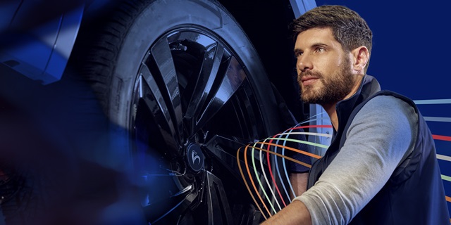 Ein Mechaniker arbeitet an einem Reifen in einer modernen Werkstatt.